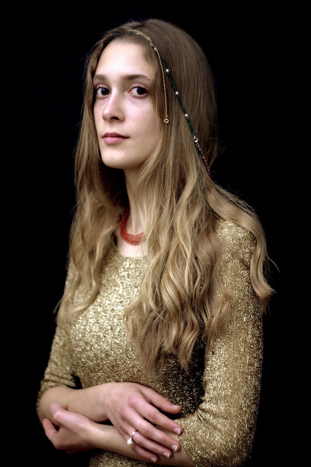Digital photograph of a woman presented like a sacred icon, dressed in golden garments against a black background. Madonnina by Paolo Gallo, Woman Portrait Gallery.